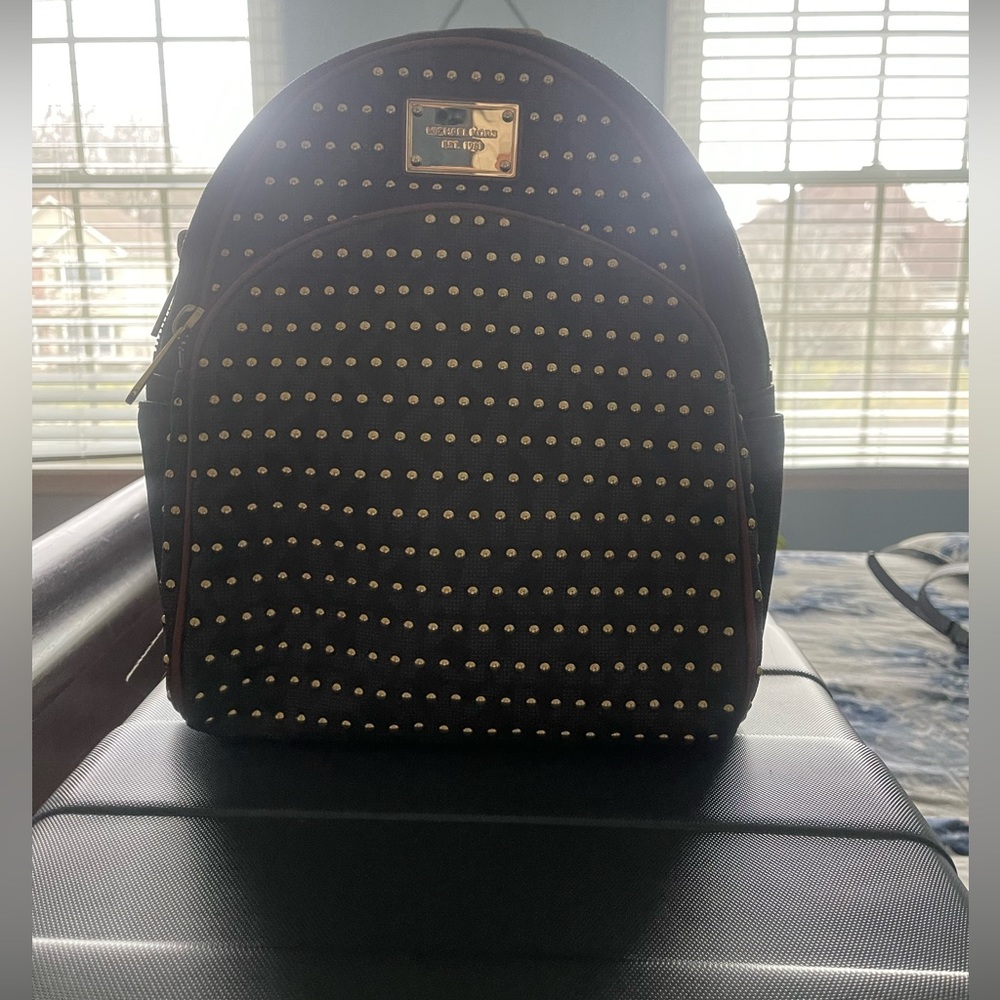 Michael Kors studded brown MK monogram with gold studs.